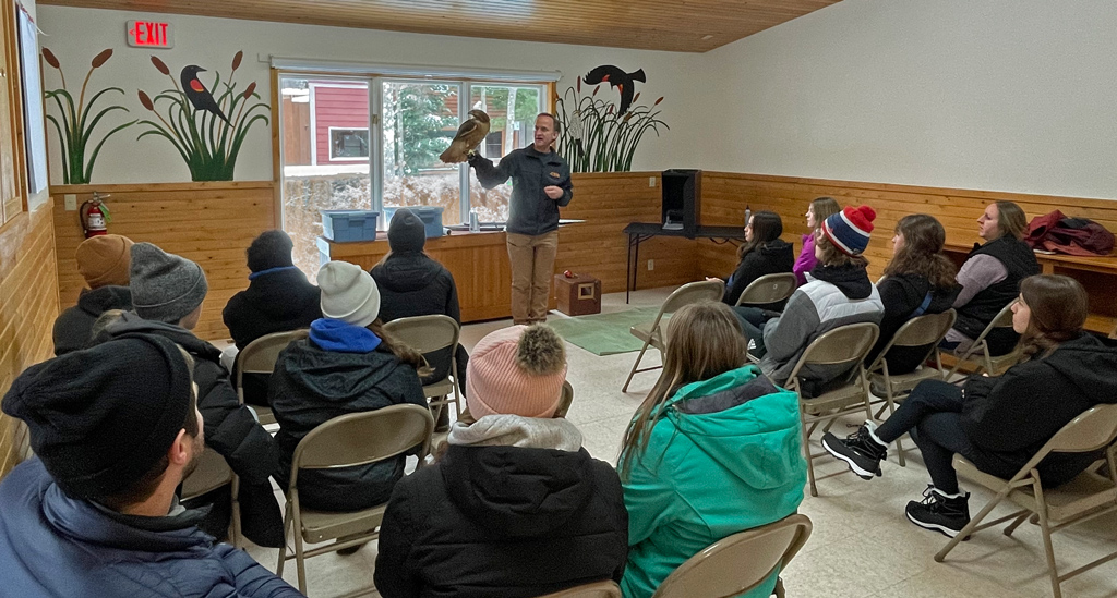 A live red-tail hawk being presented to a class at the Northwoods Wildlife Center