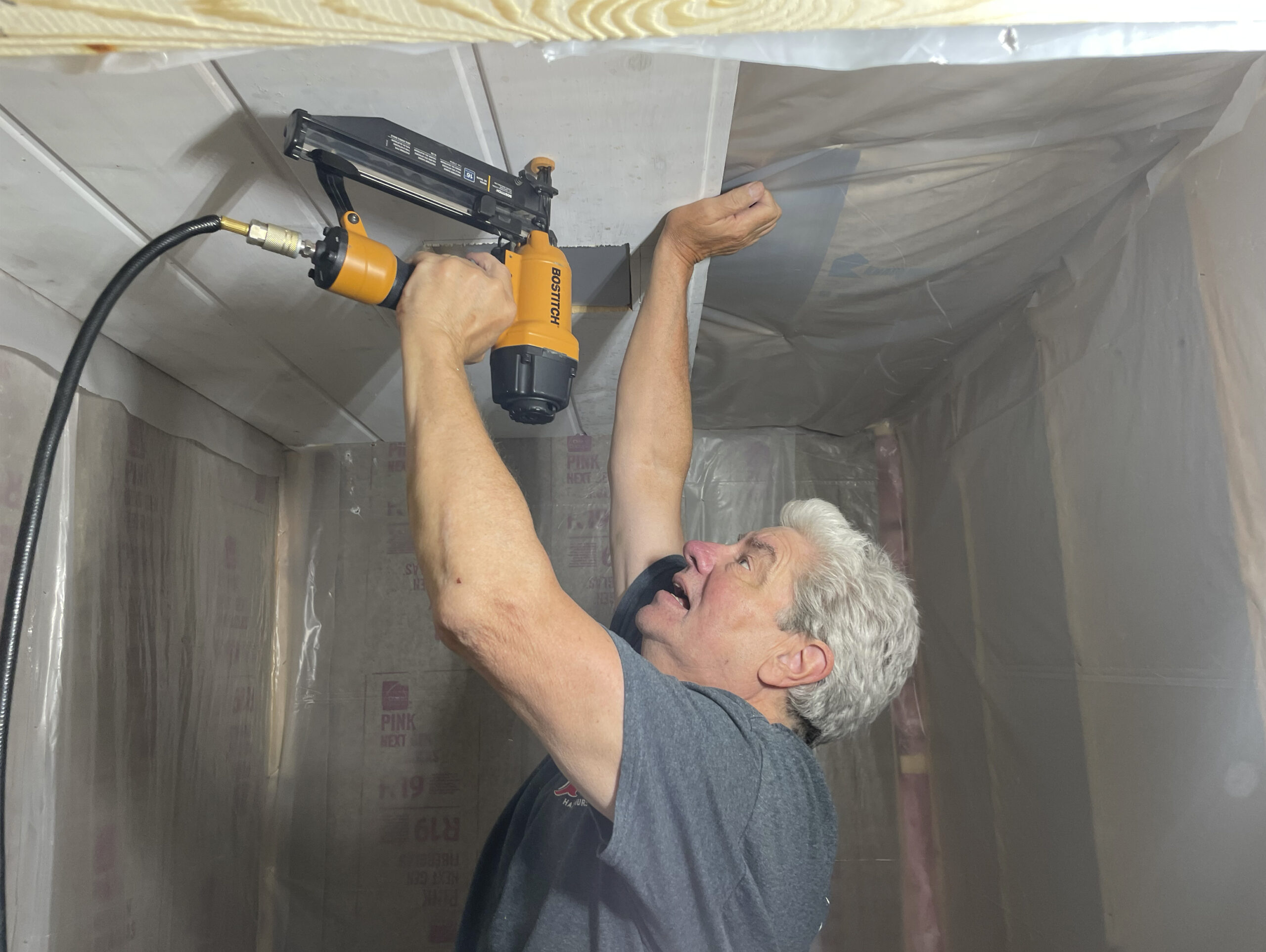 volunteer nailing paneling into the quarantine barn